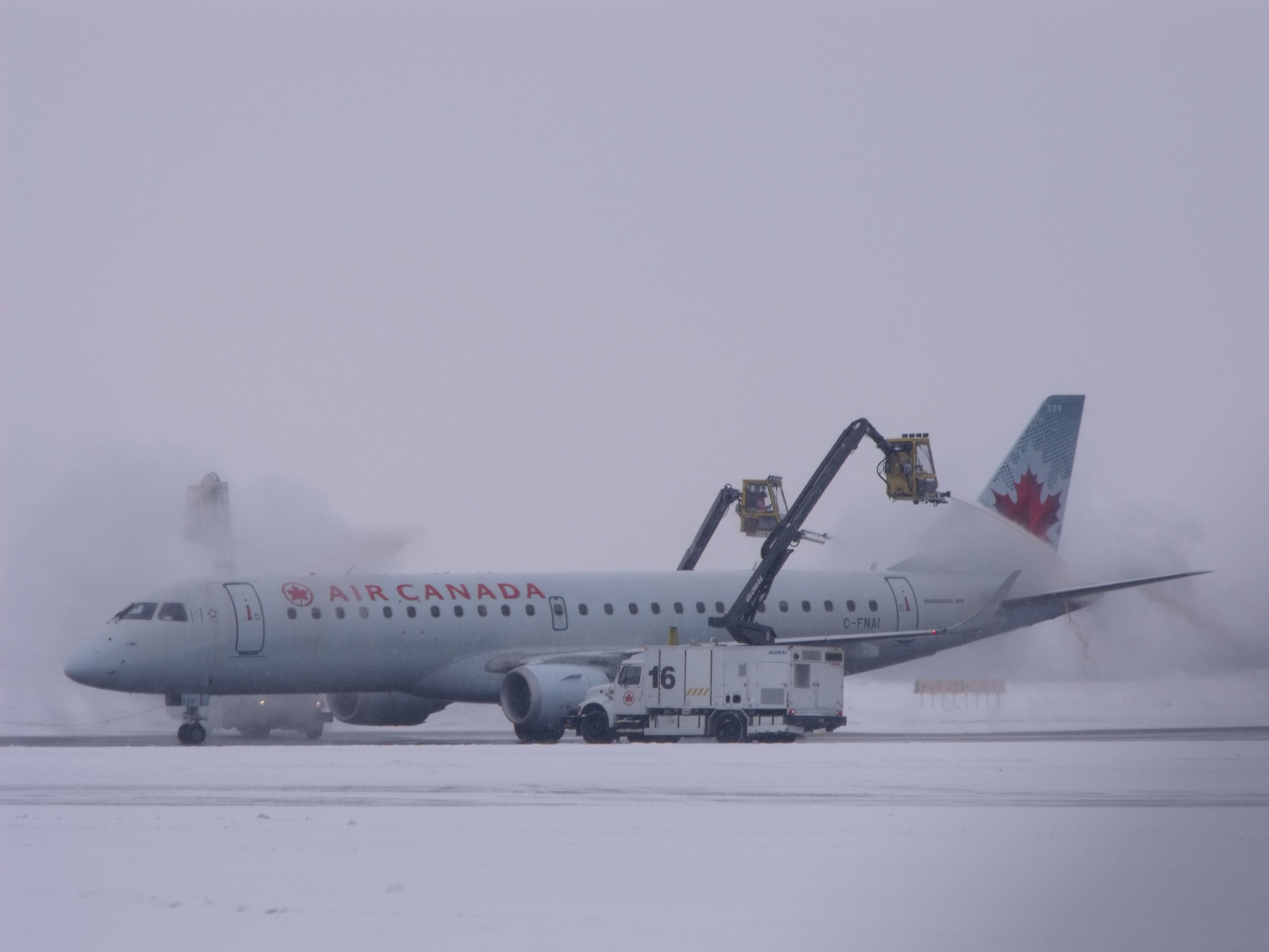 Embraer ERJ-190 (C-FNAI) - being deiced before leaving Ottawa.