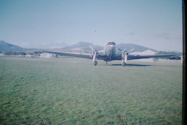 Douglas DC-3 (VH-MMF) - Air Tasmania DC3 VH-MMF parked on the grass, circa 1976