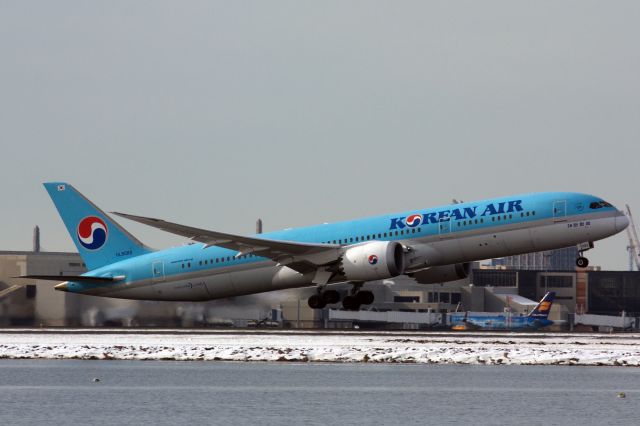 Boeing 787-9 Dreamliner (HL8082) - Korean Air departing Boston Logan's 4R while Icelandair B757-200 special livery at terminal E in back on 1/31/21.