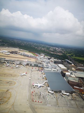 — — - Taking off. Gatwick terminal building.