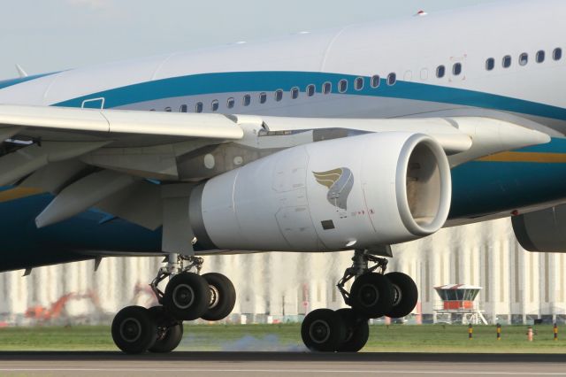 Airbus A330-300 — - Touching down on runway 027R at LHR.