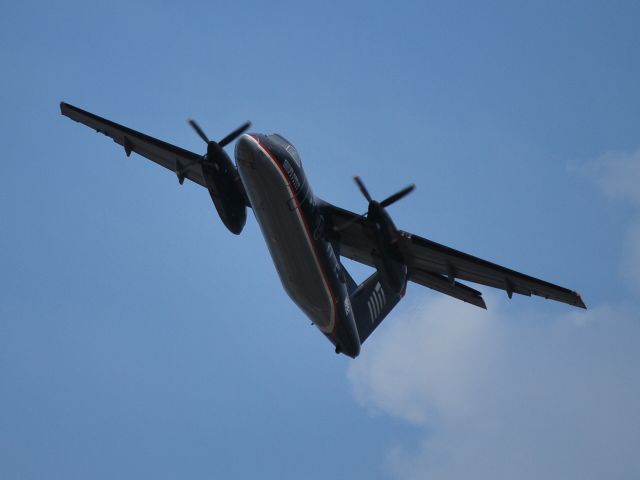 de Havilland Dash 8-100 (N815EX) - Banking to the west while departing half-way down runway 36C - 9/19/09