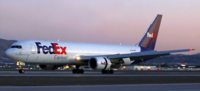 BOEING 767-300 (N114FE) - "Jade" (N114FE), a dawn hour (5:32 AM) arrival from Memphis, reverses thrust and spoils the air flow over and under the wings as it begins to slow after landing on Runway 16L.