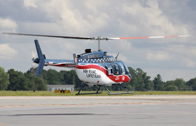 Bell JetRanger (N553AE) - Taking off from a tie-down spot before rain comes. Photo taken on 8/23/2020.