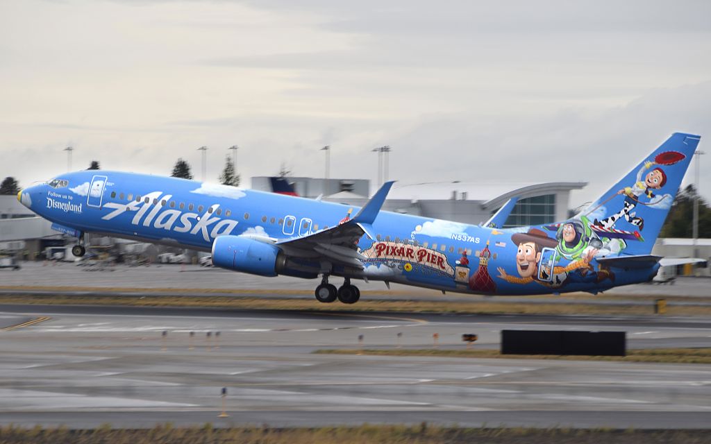 Boeing 737-700 (N537AS) - Alaska says "Follow Us To Disneyland" with their special Pixar Pier livery taking off from Spokane International.