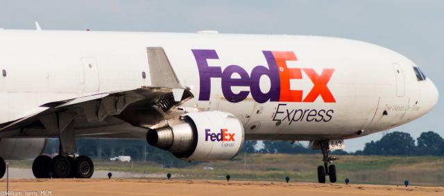 Boeing MD-11 (N643FE) - N643FE lines up on runway 18R while I shoot it on the overpass on Jim McGehee road.