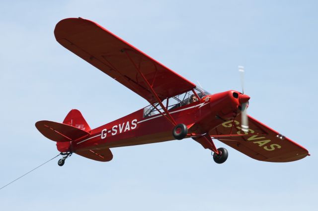 Piper NE Cub (G-SVAS) - PA-18 Super Cub, performs a flypast at Old Warden Aerodrome trailing a tether.