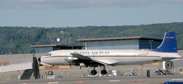 Douglas DC-6 — - Notice the flat angle on taking off till building up airspeed to climb out.