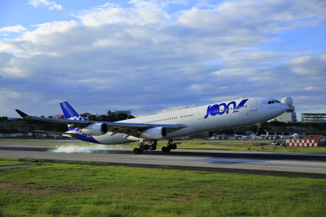 Airbus A340-300 (F-GLZO) - Joon airlines landing at TNCM St Maarten. br /Photo taken at El Zaphiro restaurant 