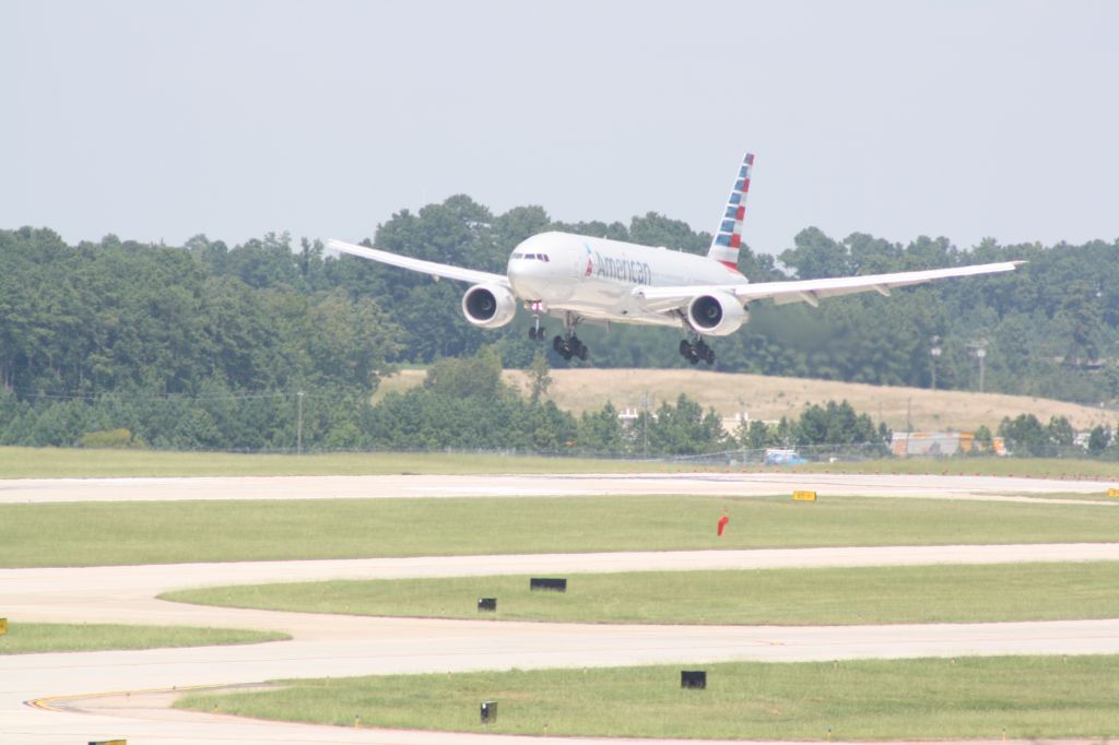 Boeing 777-200 (N767AJ) - N767AJ over the numbers for runway 23R