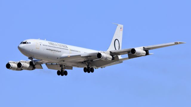 Boeing 707-300 (N707MQ) - Omega's 707-320C, modified as an aerial refueling aircraft with a drogue and designated by the company as a KC-707, arrives into March ARB after flying a refueling track off the coast.