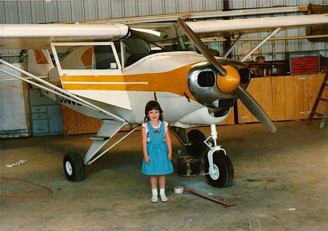 Piper PA-22 Tri-Pacer (N5565Z) - My daughter standing in front of my sister airplane