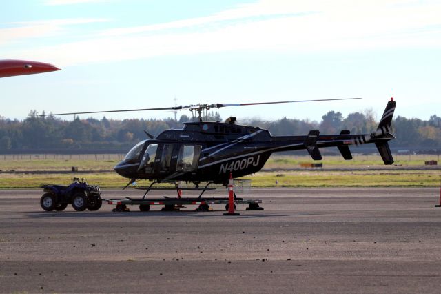 Bell 407 (N400PJ) - KCIC - Bell 407 on the hangar dolly running high RPMs.....then it took off! I did not see anybody in the right seat - but reviewing the photos i can see the knee of the Pilot...................."Lamont"..! 11-08-2016