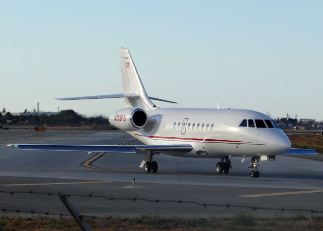 Dassault Falcon 2000 (N783FS) - Taxiing to takeoff Runway 30R. Apologies for the fence in the way