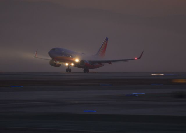 Boeing 737-700 — - Pre-dawn takeoff through ground fog from LAX, Los Angeles, California USA, Runway 24L Sorry, cant see the tail number. 3 January 2014 06:40 AM.