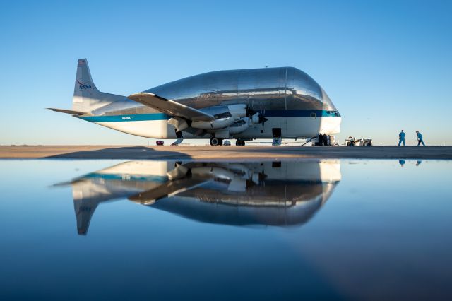 N941NA — - NASA's one of a kind Super Guppy reflects against a recent rain puddle as her pilots approach.