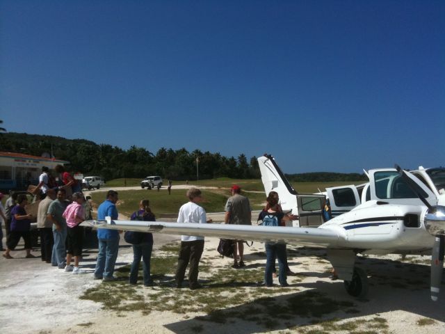 Beechcraft Baron (58) (N359P) - Unloading medical supplies in Jeremie, Haiti on Jan 18, 2010.  Picked up a group from St Cloud Mich that had been stranded by the earthquake.