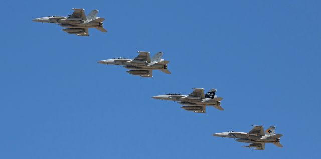 16-8381 — - Passing over rather high up in the deep blue morning sky, a division of US Navy fighters consisting of three VAQ-142 "Gray Wolves" EA-18G Growlers and a VFA-146 "Blue Diamonds" FA-18E Super Hornet returns from a morning training exercise and is about to break the echelon right formation and come around to land at NAS Fallon (KNFL).  Two of the four aircraft seen here are CAG colorbirds: the "Gray Wolves" CAG Growler (168381) is the third aircraft down the diagonal and the last aircraft is 165783, the VFA-146 CAG bird.