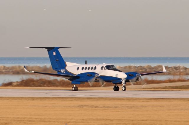 Beechcraft Super King Air 300 (N73) - Flight Check 73 during an early morning departure on RWY 6L amidst a scenic Cleveland/Lake Erie backdrop on 27 Mar 2019.