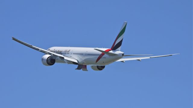 BOEING 777-300 (A6-EGX) - UAE777 climbs from runway 34L to begin its delivery flight to Dubai Intl (OMDB / DXB) on 8/31/12.  (LN:1037  c/n 35602).