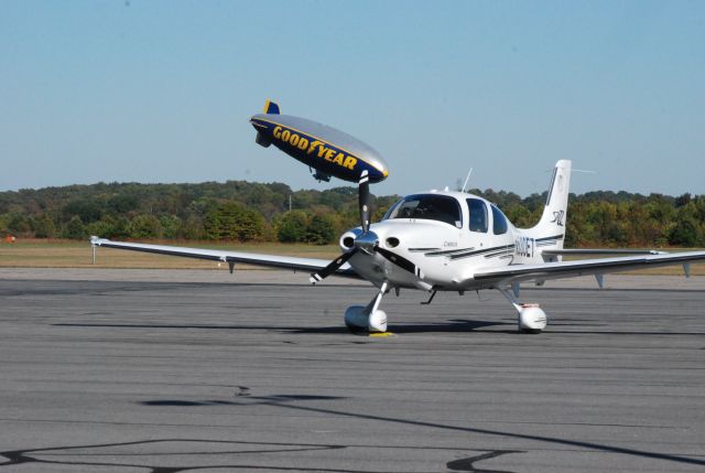 Cirrus SR-22 (N530ET) - Cirrus SR22 in at Danville Regional Airport, Danville Va. as the Goodyear blimp moves into position behind and the mooring post for a weekend in Danville and flyovers at nearby Martinsville Speedway .  10-19-09