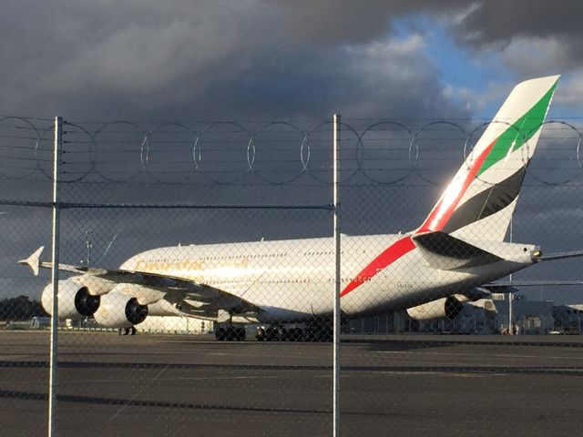 Airbus A380-800 (AE-EUM) - Emirates A380 backed up for departure from Christchurch under barbed wire.