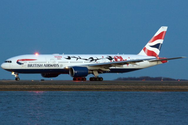 Boeing 777-200 (G-YMML) - British Airways B772 in special 'Great Festival of Creativity' livery departs BOS at dusk for LHR on 4/11/22.