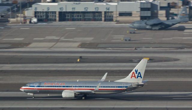 Boeing 737-800 (N851NN) - This snap taken thru the blue shades of Reno Tahoe Internationals control tower shows Americans N851NN rolling past the Nevada Air Guard "High Rollers" ramp and Fire Department facilities while accelerating down runway 16R.