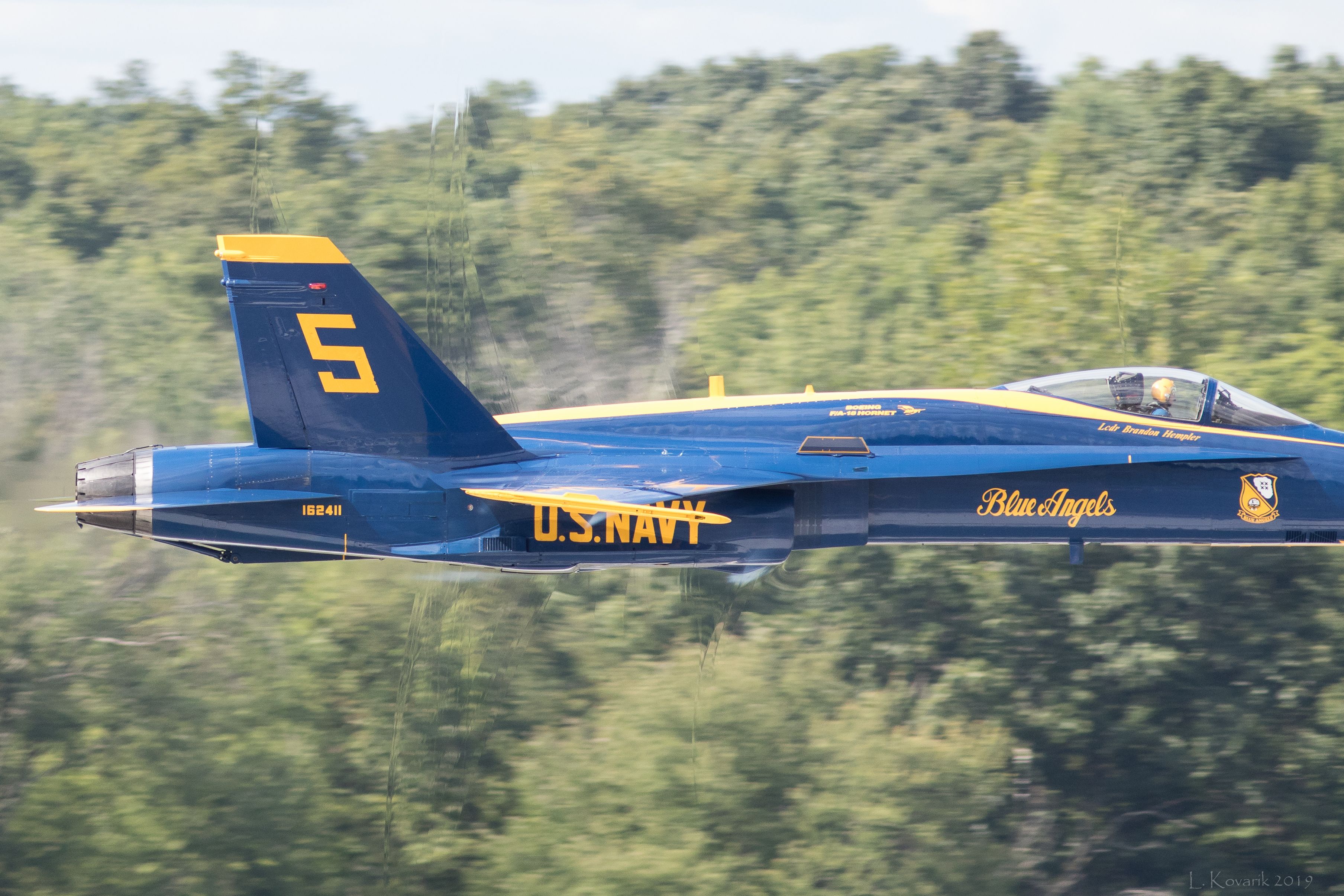 McDonnell Douglas FA-18 Hornet — - Shock waves! A 700+ mph flyby reveals shock waves as they form over the canopy and engine nacelles. Nose was sadly cut off from the pic, but she was moving so fast!!