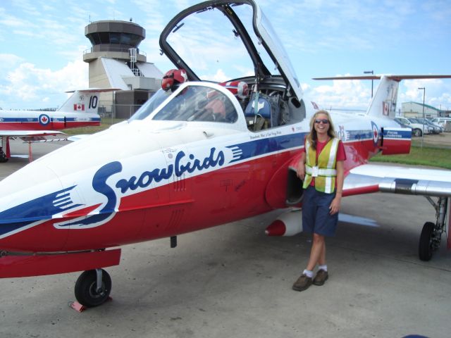 — — - A smiling member of the ground staff at the Fort McMurray Airport in Alberta, Canada enjoying a visit from the Canadian Forces Snowbirds