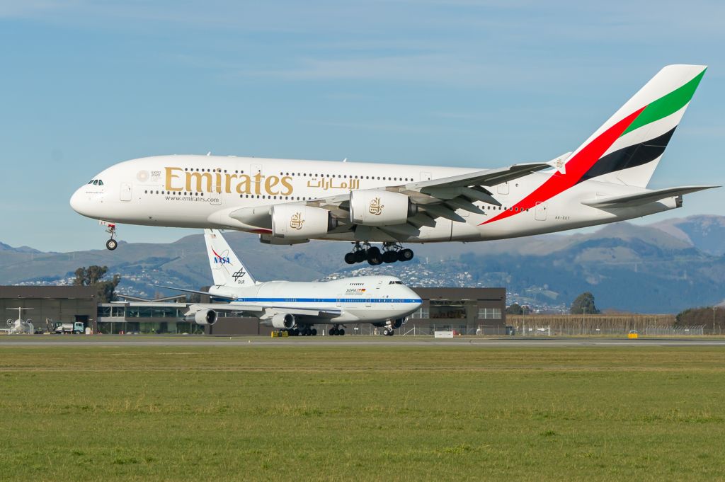 BOEING 747SP (N747NA) - Probably a "once only" capture of the "daily whale flight arrival" into Christchurch with such a gorgeous aircraft waiting in the background!br /On 20 July, SOFIA (N747NA), our part time resident B74S, was scheduled to depart and fly back to Palmdale AFB via Hawaii, but was a little early at the holding point, so had to give way to the landing A380. And I was ready up the ladder to see over the fence and capture the beaut "8 engine meet".br /I understand that Christchurch is the smallest international airport to serve the A380, and we get one daily. So, for a small country and small airport, we certainly get some unique "Heavies" and "Supers-Heavies" quite regularly.