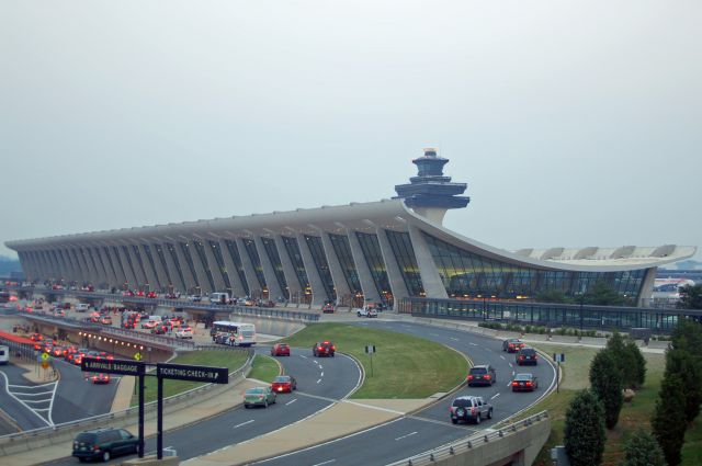 — — - Dulles Airport before a thunderstorm on a summer afternoon.