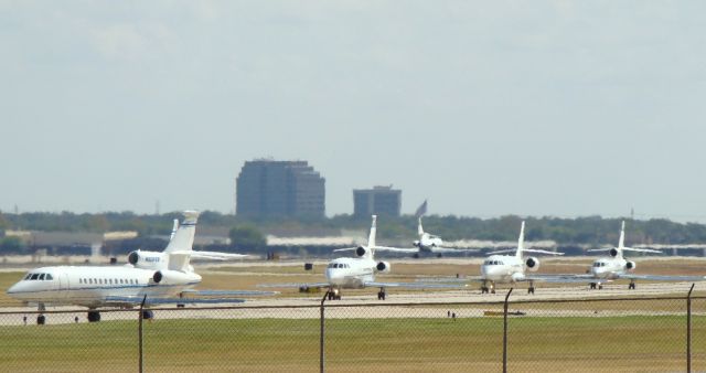 Dassault Falcon 900 — - six of AT&Ts Falcons in one shot, one rolling down 12R, and five on taxiway, one is mostly blocked by the 900 on left,not the best shot, but a unique one.