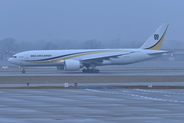 BOEING 777-200LR (N707GT) - MSC AIR CARGO "Antares" departing 23-R in the Fog at sun-up on 12-07-22 headed to LGG. Aircraft owned and operated by Atlas Air.