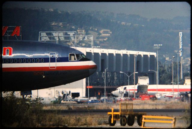 McDonnell Douglas DC-10 (N109AA) - SFO- 1000mm lens shot of Runway 1R action at SFO. the late 1980's shot taken from atop my ladder in the back of my truck. Note the 2 TWA Cargo 707's in the background.
