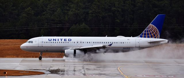 Airbus A320 (N465UA) - Love a good spray! From the RDU observation deck, 2/7/18.