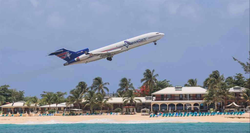 BOEING 727-200 (N495AJ) - Gone are the past where could of relax on the beach while watching the wonderful view of them metal birds zoom by. Here we have Amerijet Boeing 727 Registration N495AJ seen departing St Maarten for MIA. 