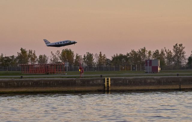 Piper Navajo (C-FNAG) - Low takeoff route into the dusk.