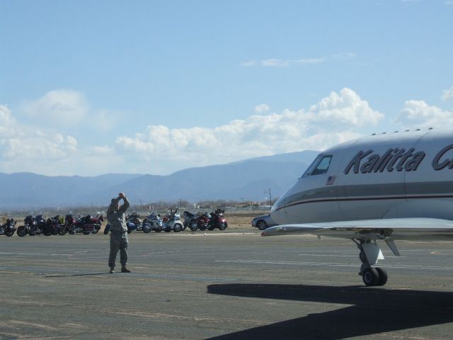 AMERICAN AIRCRAFT Falcon XP (N227CK) - Kalitta Charters bringing a fallen hero home.  Note the Motorcycles in the back they are the Patriot Guard Riders and the Soldier directing the aircraft to stop