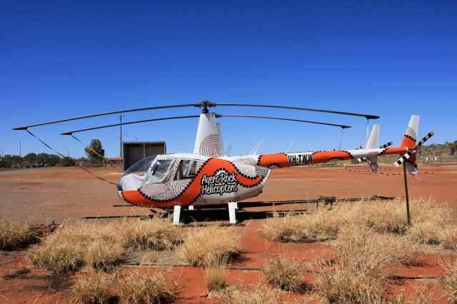 Robinson R-44 (VH-TWW) - If you are going to do heli tours of the Rock then jazz up the Robbo in Indigenous Art like this one at Ayres Rock NT Australia seen recently