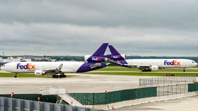 Boeing MD-11 (N573FE) - Tag team. Taxiing for departure while identical N595FEbr / arrives 13R.