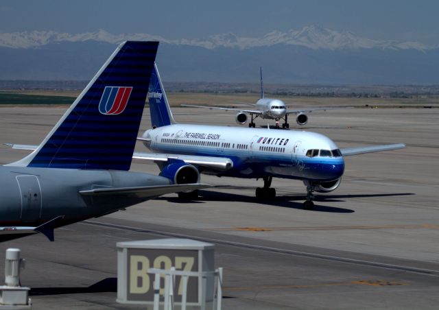 Boeing 757-200 (N542UA) - Me and my father were on our way home from South Dakota. We went into a restaurant and we saw the Oprah Farewell Season 757-222 with beautiful snow top mountains and Pikes Peak in the background. I had to get some photos since she was born in my home State. The other 2 aircraft are 757's as well. One in old paint scheme. Denver is usually bumpy coming in and it didn't change that day, but it's beautiful.