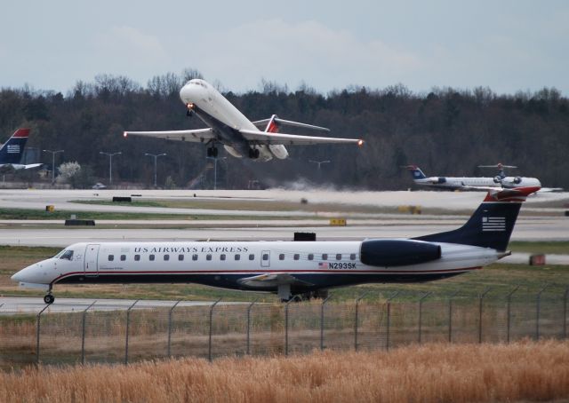 Embraer ERJ-145 (N293SK) - Waiting for Delta DC95/N780NC to pass before crossing the center runway (18C/36C) - 3/9/12