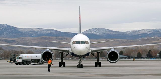 Boeing 757-200 (N652DL) - The chartered Delta B752 (N652DL) transporting the Las Vegas Golden Knights National Hockey League team is marshalled to its parking spot on November Pad after arriving from KLAS.  The flight was bringing the Golden Knights to Reno where the team was transported to the Edgewood Resort in Stateline, Nevada, to play a game against Colorado in the "NHL Outdoors at Lake Tahoe" event.