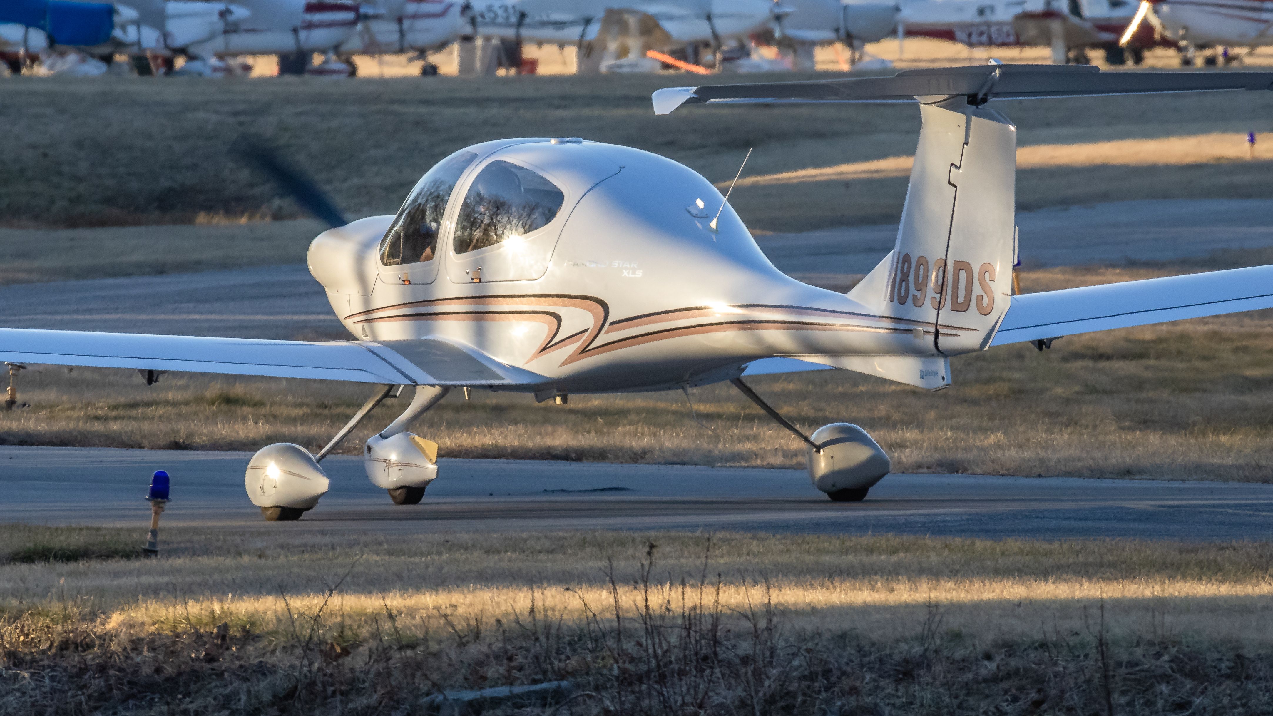 Diamond Star (N899DS) - N899DS turning off of College Park Airport's runway 15 during golden hour 