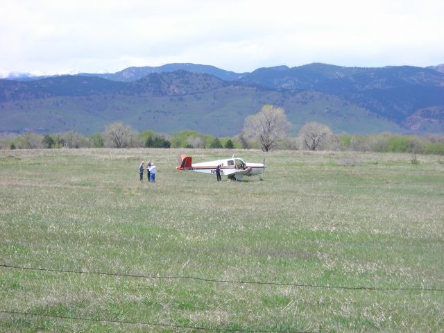 Beechcraft 35 Bonanza (N8SM) - damaged plane in field ... you can see that the right wing is damaged from going through the fence (possibly) to come to rest in this field.