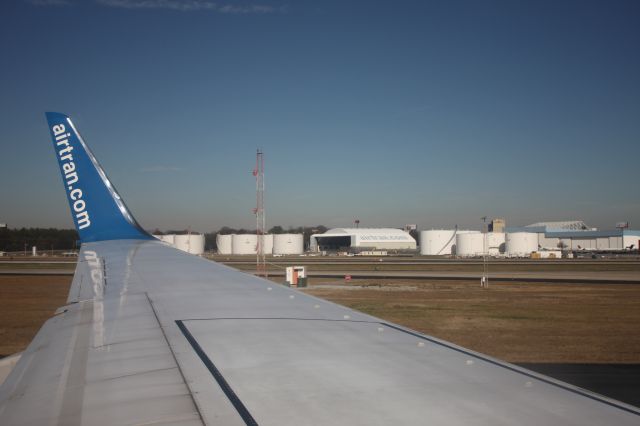 — — - AirTran's maintenance hangar is visible on our takeoff roll to LAX.