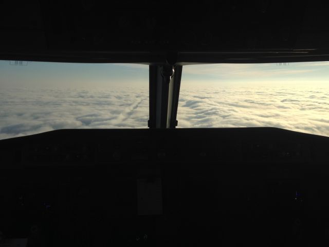 Fokker 70 (PH-KZB) - Approaching RWY 18R of EHAM with a low ceiling, It was just above CAT I minimums. You clearly can see the trail of previous traffic penetrating the clouds.