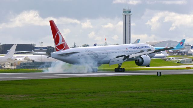 BOEING 777-300 (TC-JJZ) - BOE538 makes tire smoke on landing Rwy 16R to complete a ferry flight from KPDX on 4/2/15. (ln 1291 / cn 44122). The aircraft was returning after being painted.