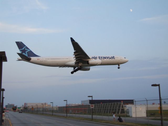 Airbus A330-300 (C-GTSO) - Over airport road....